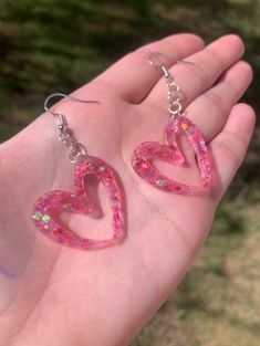 Each pair of resin earrings are made to order, therefore no two pairs are identical! However, I try to get as close as possible :) Made with nickel free, hypoallergenic, sterling silver plated fish hooks.  Heart is approximately 3cm x 3cm and is made with epoxy resin and hot pink glitter mix with stars  💖 Please note that the hearts will hang at an angle. Thanks for visiting my shop! ✨ Hot Pink Glitter, Valentines Earrings, Resin Ideas, Fish Hooks, Pink Sparkly, Glitter Earrings, Heart Dangle Earrings, Fish Hook Earrings, Clothing Inspiration