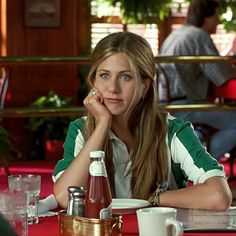 a young woman sitting at a table in a restaurant