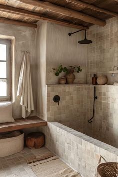 a bath room with a tub and a window next to a shelf filled with plants