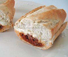 two pieces of bread with meat inside on a plate