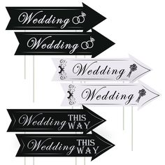 four black and white wedding directional signs