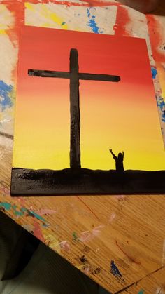 a painting of a person standing in front of a cross that is painted on wood