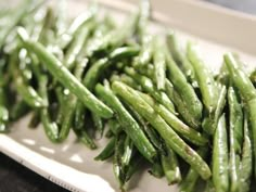 green beans are sitting on a plate ready to be cooked in the oven for dinner