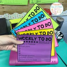 a person holding up a pile of sticky notes with the words to do on them