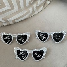 four heart shaped magnets with the words mr and mrs on them, sitting on a couch