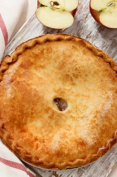 an apple pie sitting on top of a wooden table