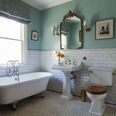 a bathroom with a toilet, sink and bathtub in the middle of tile flooring