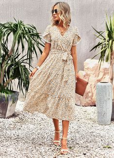 Add a touch of romance to your everyday look with the Lilacoo Floral Print Wrap Maxi Dress. The ultra-soft, textured woven fabric features a beautiful floral print, creating a charming and feminine vibe. The dress drapes into a surplice bodice, framed by fluttering short sleeves with slits. The wrap maxi skirt has a tying waist sash, accentuating your waistline and creating a flattering silhouette. Elevate your style game and embrace the romance with this delightful dress. Pattern: plants and flowersTechnology: printingSkirt length: medium and long skirtSkirt type: A-line skirtCollar type: V-neckSleeve type: lotus leaf sleeveSleeve length: short sleevesWaist type: high waistPopular elements: lace-upsColor: black, light green, apricot, purpleSize: S,M,L,XL