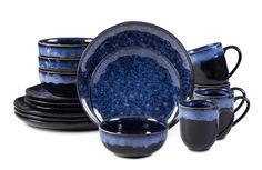 a blue and black dinner set with cups, saucers, and plates on white background