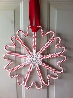 a candy cane snowflake hanging on a door