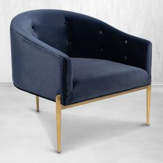 a blue velvet chair with gold legs