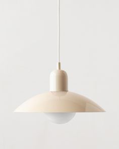 a white light hanging from a ceiling fixture