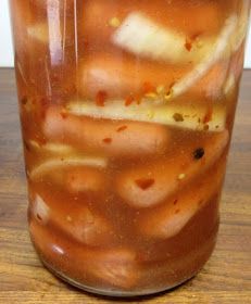 a jar filled with liquid sitting on top of a wooden table