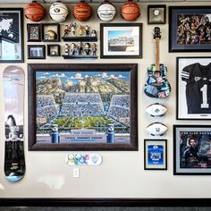 a wall covered in pictures and sports memorabilia, with a skateboard propped against the wall