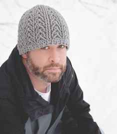 a man wearing a knitted hat in the snow