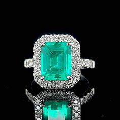 Gorgeous 14K white gold emerald engagement ring. center  lab grown emerald in rectangular shape. weight 3.10ct. size 10x8mm  nice vivid green colombia color,clean, very lively ,nice cut,side set natural rounds diamonds total weight 0.75ct H-SI1  Ring SIZE 7 Resizable  Retail value $6,500 net.  Cert Appraisal available Green Diamond Ring With Vvs Clarity And Radiant Cut, Green Emerald Cut Ring With Halo Setting, Gia Certified Emerald Cut Green Rings, Green Emerald Cut Diamond Ring, Green Rectangular Diamond Ring With Prong Setting, Rectangular Green Emerald Diamond Ring, Formal Green Rectangular Diamond Ring, Gia Certified Square Cut Green Emerald Ring, Rectangular Green Emerald Ring With Vvs Clarity