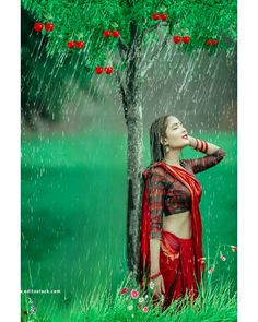 a woman standing under a tree in the rain