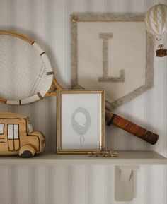 there is a baseball bat on the shelf next to a picture frame and other items