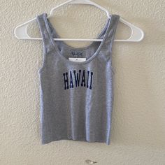 Comfy Classic Scoop Neck Ribbed Tank Top In Heather Grey With A Raw Hem And The Hawaii Graphic On The Front. Fabrics: 100% Cotton Measurement: 46 Cm Length, 29 Cm Bust Made In: Europe Casual Letter Print Tank Crop Top, Casual Tank Top With Letter Print, Gray Stretch Cotton Crop Top, Summer Gray Cotton Crop Top, Casual Fitted Tank Top With Letter Print, Scoop Neck Top With Letter Print For Spring, Gray Sleeveless Top For Vacation, Vacation Tank Top With Letter Print, Letter Print Tank Top For Vacation