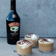 three desserts with whipped cream and bailey's irish cream in front of a bottle