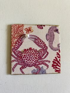 a red crab and seahorse on a white background with pink, purple, and orange accents