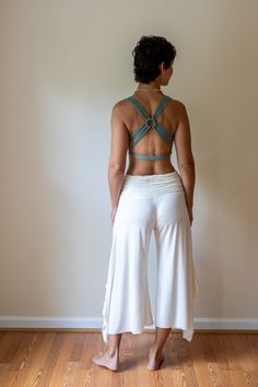 A top-selling tank from our shop for over a decade, this strappy yoga tank is made from the highest quality sustainably sourced cotton lycra blend.  The woven back adds a unique flair. Great for yoga, pilates & dance. Also looks amazing under backless tops. Paramita Designs clothing makes for excellent travel wear on your next adventure! Shown here in Sage with the white Mini Skirt and Ruffle Pants. Hand or machine wash cold delicate cycle. While drying on a gentle cycle will not damage the top, the longevity of the top will be maintained by hanging to dry.  Fair Trade - Handmade - Sustainable Hippie Yoga Outfits, Seamless T-back Halter Top For Yoga, Summer Yoga Tank Top With Built-in Bra, Yoga Crop Top With Built-in Bra And Strappy Back, Yoga Tank Top With Built-in Bra And T-back, Summer Gym Crop Top With Strappy Back, Athleisure Crop Top With Adjustable Straps For Yoga, Yoga Tank Straps Crop Top, Yoga Crop Top With Tank Straps And Bra Friendly