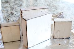 three wooden blocks sitting on top of a table