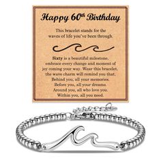 a bracelet with a happy 60th birthday message on the front and an image of a wave