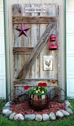 an old barn door is decorated with flowers and other decorations for the front entrance to this home