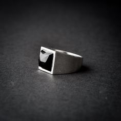 A handmade sterling silver 925 square shaped onyx stone signet ring. Each ring is cleaned and polished with care. The weight of the ring may vary according to size. Top measurements: Width - 13mm | Hight - 13mm Approx weight: 8.14gr The ring is set with one square shaped, rose cut black onyx stone. *The ring is hollowed out from the inside* This ring is made to order! Please allow up to 21 business days to be made before shipment. If you have any further questions, please don't hesitate to conta Modern Onyx Signet Ring For Gift, Modern Onyx Signet Ring Gift, Minimalist Silver Onyx Signet Ring, Modern Silver Ring With Rectangular Stone, Modern Silver Rings With Rectangular Stone, Modern Black Sterling Silver Signet Ring, Rectangular Onyx Signet Ring Gift, Modern Sterling Silver Jewelry With Square Cut, Modern Sterling Silver Rings With Rectangular Stone