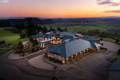 an aerial view of a home at sunset