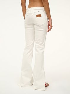 THE BIKINI JEAN The Bikini Jean is our snug fit. This low-rise jean sits below the natural waist, is fitted through the hips, with a flared leg. This style is available in 2 inseam lengths and features our STAUD belt loop detail at the waist, as well as slit detailing at the bottom of each pant leg. White Wrangler, White Flare Jeans, Wrangler Women, White Flared Jeans, Low Rise Jean, Jean Belts, Wrangler Jeans, Cute Fits, Flare Jeans