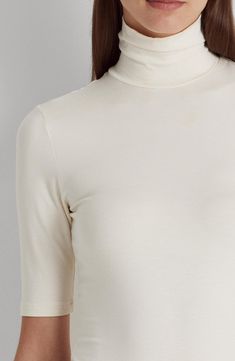 Cut from a smooth, stretchy jersey with a refined feel, this turtleneck is a chic addition to your look whether worn alone or as part of your layered look. 24" length (size Medium) Turtleneck Elbow-length sleeves 97% viscose, 3% elastane Machine wash, dry flat Imported Fitted High Neck Turtleneck, Chic Funnel Neck Turtleneck, Chic Solid Color Funnel Neck Turtleneck, Chic Solid Turtleneck With Funnel Neck, Elegant Stretch White Turtleneck, Elegant White Stretch Turtleneck, Classic Funnel Neck Top For Layering, Chic Fitted Turtleneck In Solid Color, Elegant Stretch Top With Funnel Neck