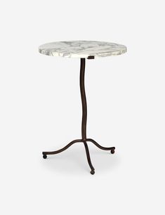 a marble top table with an iron base and two wheels on the legs, against a white background