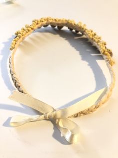 "Shell Choker. Strung from dried, braided palm leaves are olive shells embellished by tiny delicate shells. Very regal jewel from the sea. 16\". Ribbon closure." Traditional Adjustable Shell Jewelry, Gold Handwoven Beach Jewelry, Gold Handwoven Jewelry For Beach, Adjustable Braided Gold Jewelry, Adjustable Gold Braided Jewelry, Handwoven Adjustable Jewelry For Vacation, Beach Gold Hand Wrapped Jewelry, Adjustable Handwoven Jewelry For Vacation, Delicate Handmade Jewelry For The Beach