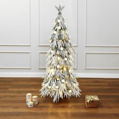 a small white christmas tree with gold ornaments