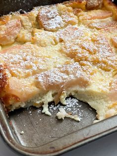 a close up of a cake in a pan with powdered sugar on the top