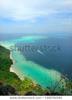 an aerial view of the tropical island with clear blue water