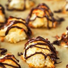 chocolate drizzled on pastries sitting on a baking sheet