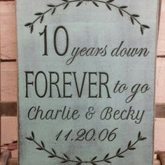 a wooden sign that says 10 years down forever to go charlie and berdy on it