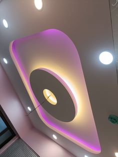 the ceiling is decorated with circular lights and round shapes, along with recessed lighting