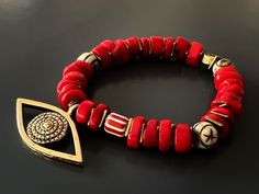 The Red Coral Evil Eye Bracelet displays a unique vibrant style and has immense spiritual and protective power. Featuring red coral stones and a large evil eye charm this bracelet is stylish and powerful to wear during meditation and daily life. The Evil Eye is a prominent symbol in Turkish and many other cultures, and is highly protective. Evil Eye is also called nazar. Evil Eye beads reflect ill intent and jealousy from the 'evil eye' back to the person thinking of it, hence protecting the wea Traditional Red Bracelets For Meditation, Red Spiritual Beaded Bracelets For Blessing, Spiritual Red Beaded Bracelets For Blessing, Red Spiritual Gemstone Beaded Bracelets, Spiritual Red Gemstone Beaded Bracelets, Red Spiritual Beaded Bracelets With Gemstone Beads, Red Gemstone Beaded Spiritual Bracelets, Red Spiritual Beaded Bracelets For Meditation, Red Gemstone Beads Bracelets For Meditation