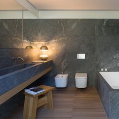 a modern bathroom with marble walls and flooring