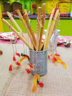 a tin can filled with wooden sticks on top of a table