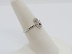 Vintage Sterling Silver Garnet & White Topaz Hamsa Ring ....Marked 925...Total of weights 1.7grams...Size 7...Measure of Face 10.9MM...It's in very good condition. White Gold Sterling Silver Ruby Ring With Diamond Accents, Silver Ruby Ring With Diamond Accents As Gift, Hand Set Sterling Silver Diamond Ring, Hand Set Sterling Silver Promise Ring, Silver Ruby Ring With Diamond Accents, Hamsa Ring, White Topaz, Stackable Rings, Vintage Sterling Silver