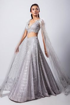 Grey attached cancan embellished lehenga. Paired with an embroidered padded blouse with floor length cape sleeves. - Aza Fashions Embellished Lehenga, Sangeet Lehenga, Cape Lehenga, Fringe Cape, Blouse Satin, Lehenga Pattern, Padded Blouse, Royalty Aesthetic, Grey Blouse