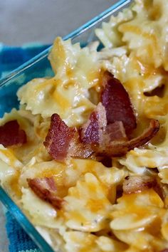 a casserole dish with bacon and cheese in it on a blue glass plate