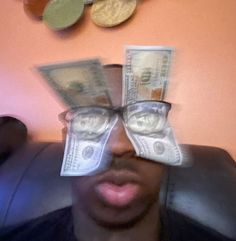 a man with glasses and money sticking out of his eyes