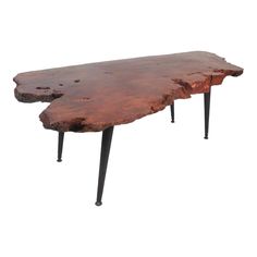 a wooden table with metal legs and a large piece of wood on the top of it