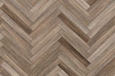 an image of wood flooring that looks like chevroned herringbones in brown tones